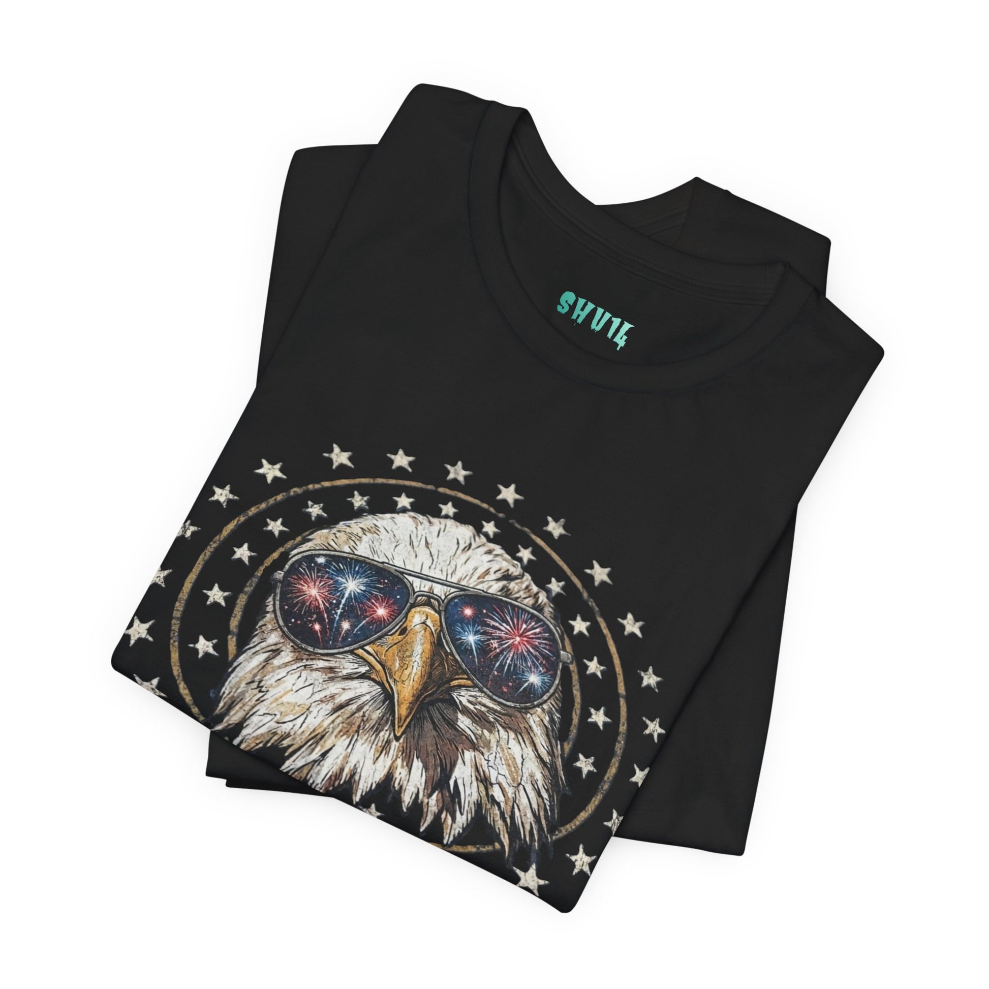Close-up graphic design of a majestic bald eagle wearing black aviator sunglasses that reflect red, white, and blue fireworks, encircled by a distressed ring of white stars against a solid black background.