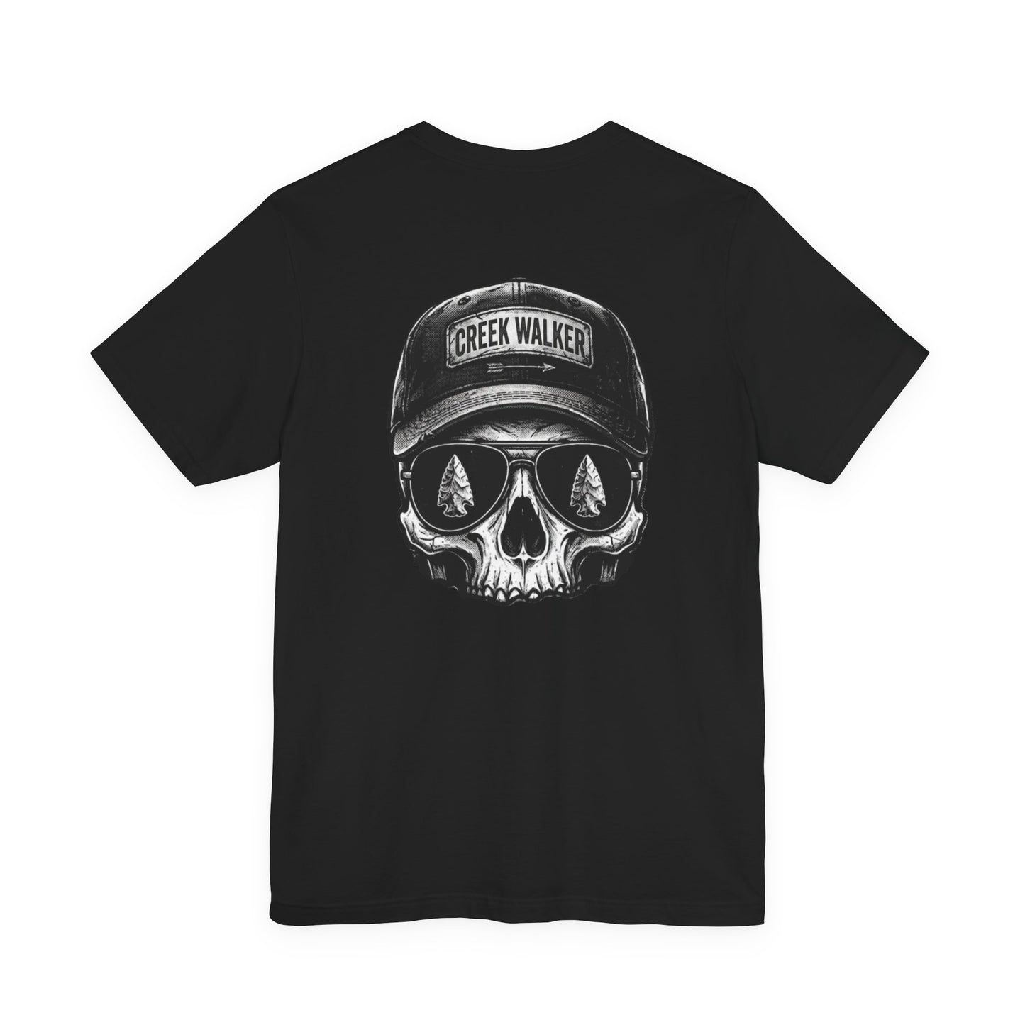Distressed monochrome graphic on a black shirt showing a human skull wearing a baseball hat with "Creek Walker" written on it and aviator sunglasses that reflect ancient arrowheads.