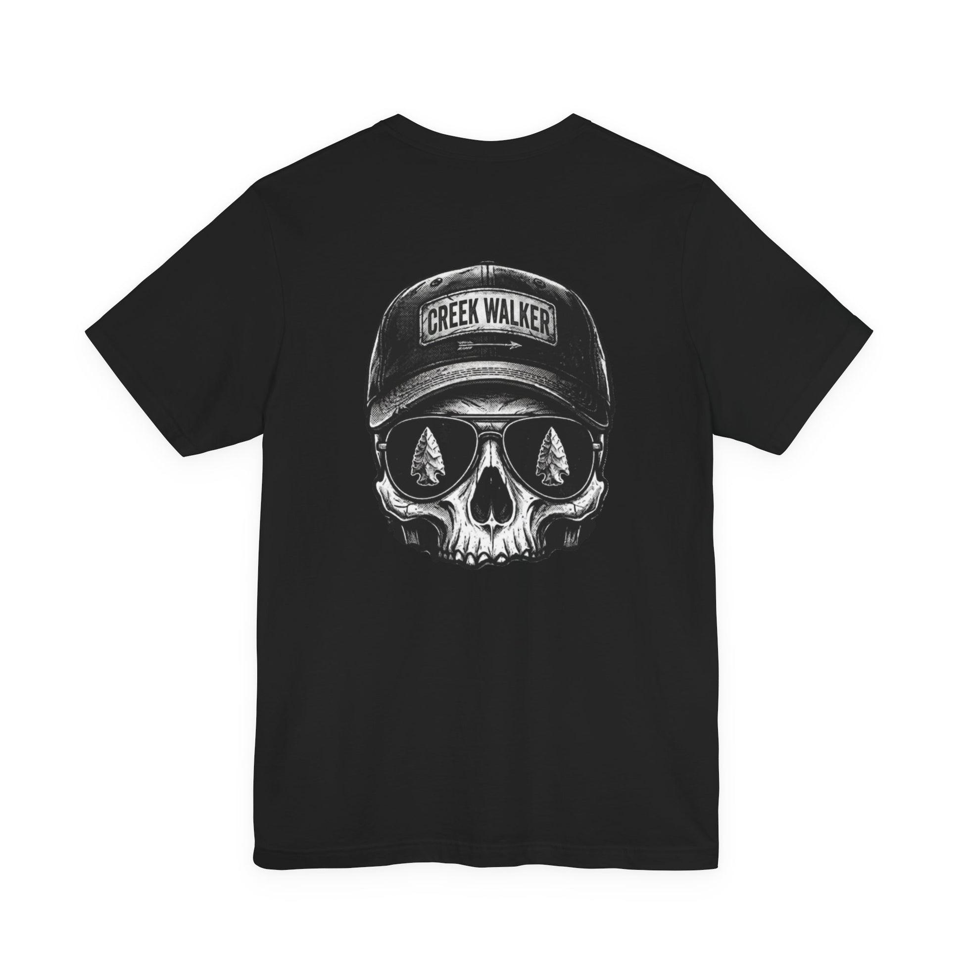 Distressed monochrome graphic on a black shirt showing a human skull wearing a baseball hat with "Creek Walker" written on it and aviator sunglasses that reflect ancient arrowheads.