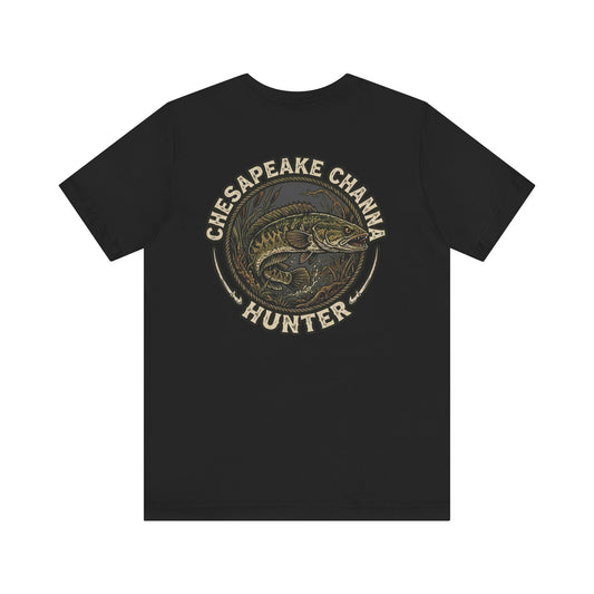 Vintage round emblem design featuring a fierce snakehead fish in marsh grass with text Chesapeake Channa Hunter on a black t-shirt.